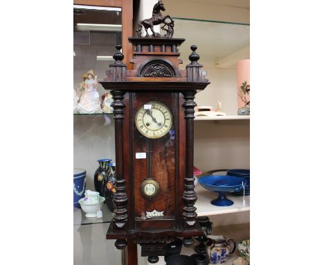 A late 19th Century Vienna style wall clock, having an eight day movement, horse finial