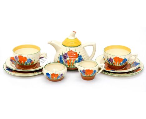 A Clarice Cliff for Newport Pottery Bizarre Crocus pattern teaset for two, comprising teapot, milk, sugar, two trios (9)