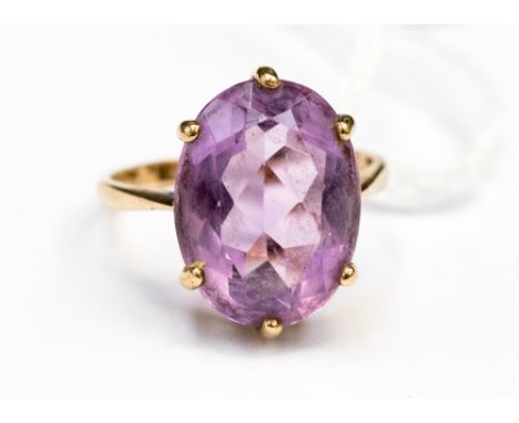 A oval Amethyst approx 15x11mm claw set ring in 9ct gold, size O½ total gross weight approx 4gms