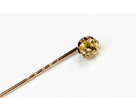 A pale yellow sapphire and rose metal stick pin, the claw set cushion cut yellow sapphire approximately 7.45 x 6.76mm