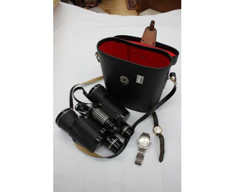 A Tissot Seaster watch, another watch and a pair of binoculars 
