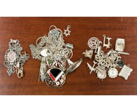 A good quantity of assorted silver jewellery to include a silver charm bracelet and assorted charms, an amber pendant chain a