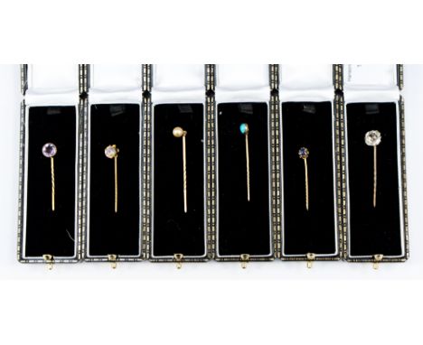 Six assorted yellow and rose metal gemset stick pins to include sapphire, bezel and millegrain set amethyst, quartz, turquois