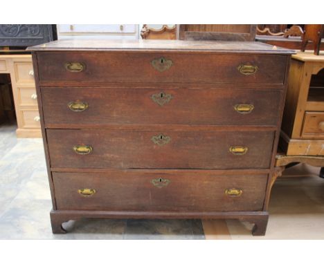 A George III oak chest of drawers, comprising four long graduated drawers, all drawers retaining original locks and escutcheo