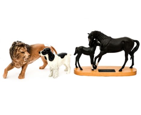 A Beswick model of Black Beauty and Foal on a wood base; together with a Beswick model of a Spaniel and a figure of a Lion (3