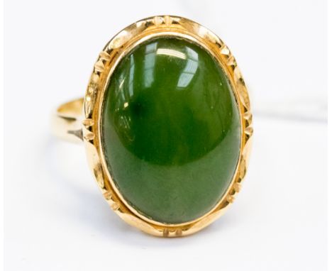 A Jade cabochon polished stone, with coloured inclusions 18ct gold, size R aprox total gross weight  6.4gms