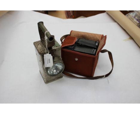 A mother of pearl safety lamp and a mid 20th century camera