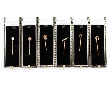 Six Victorian yellow and rose metal stick pins to include a French channel set sapphire circle with millegrain detailing 18ct