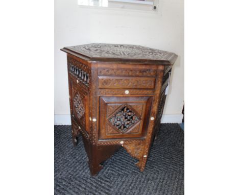 An early 20th Century Indian octagonal table, together wtih a matching hall table, both intricately inlaid with mother-of-pea