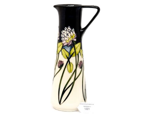 A Moorcroft pitcher in the 'trefoil' pattern, measuring approx 24cm high