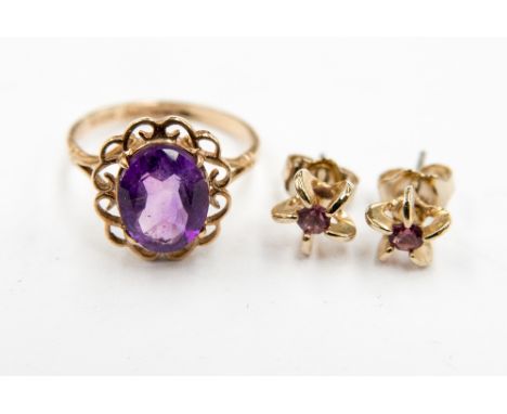 An amethyst single stone dress ring with set in 9ct gold with a scroll surround, size K; together with a pair of purple stone