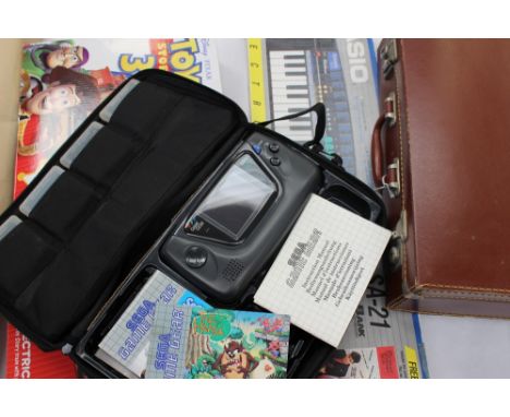 A Sega games console and games, a Hornby electric train set and a Casio SA21 keyboard and a leatherette suitcase 