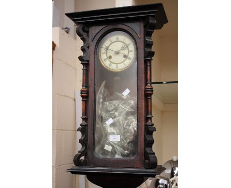 A Victorian drop-dial wall clock, enameled dial, having Roman numerals, key, pendulum and finial's 