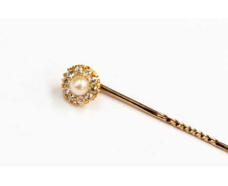 A pearl and diamond cluster yellow metal stick pin, the centre pearl approximately 4.51 x 4.49mm raised against a circular ol