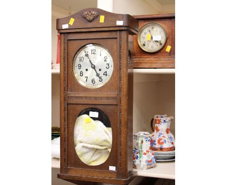 An early 20th Century oak eight day box clock; together with another 20th Century oak eight day mantel clock (2) 