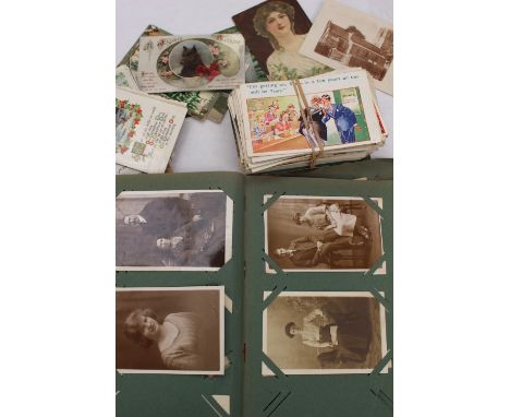 A large collection of early 20th Century postcards, in album and loose, greetings and topographical and portrait 