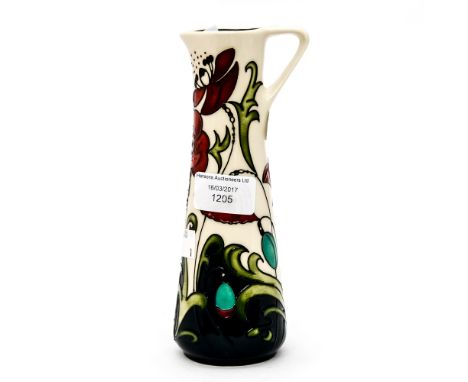 A Moorcroft pitcher in the 'poppy' pattern, measuring approx 19cm high