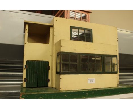 A cream and green painted Triang Ultra Modern 1930s dolls house No 52 3138, flat roof design opening at front to reveal two l