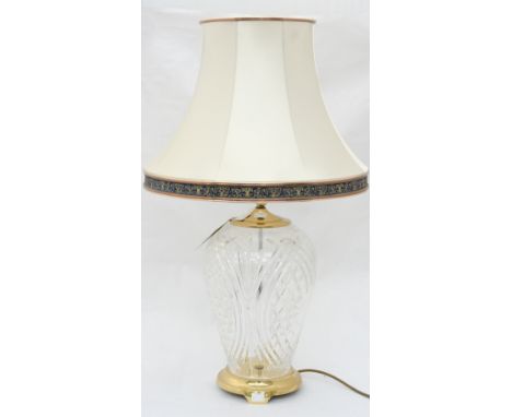 A very large Waterford Crystal lamp base with brass fittings and a cream shade with navy and gold banding, measures approx 48