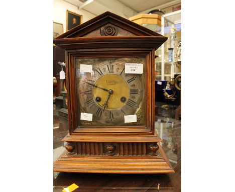 An early 20th Century mahogany mantle clock, with eight day movement, the dial with silvered chapter ring and black Roman num