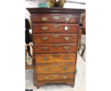 A George II and later mahogany chest of drawers, fitted with seven long graduated drawers fitted with bracket feet, some draw