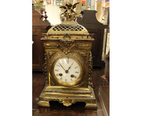 A 19th Century gilt cased eight day mantle clock, the white enamelled dial with black Roman numerals and indistinctly inscrib