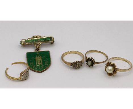 A 9ct gold and diamond cluster ring, ring size K, two other rings and a badge (4)