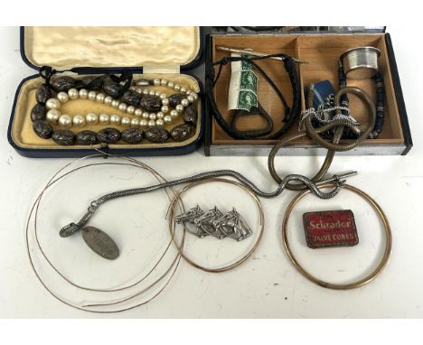 A yellow metal bangle, a quantity of yellow metal wire, a silver coloured metal brooch, in the form of three horses heads, an