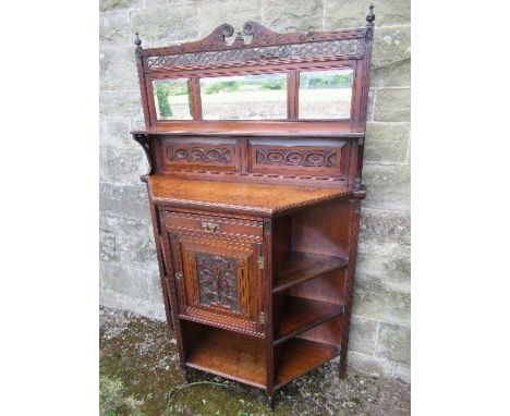 An Edwardian chiffonier / sideboard, having carved and pierced frieze over three mirrors, with bevelled plates, the base havi