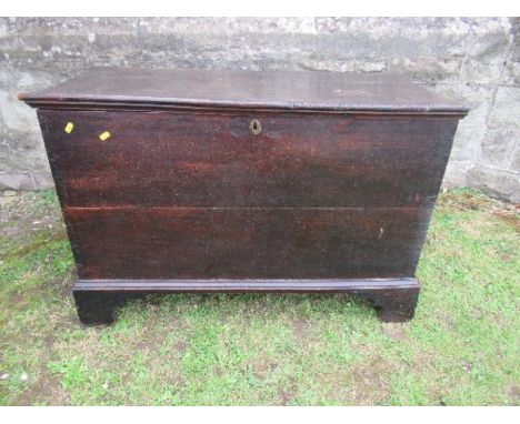 An antique oak coffer, raised on bracket feet, width 42ins x depth 19.5ins x height 29ins