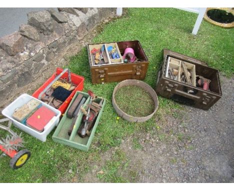 A collection of tools, including two ammo boxes and contents
