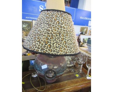 A table lamp, the round metal base having lug handles to each side, with an animal print shade