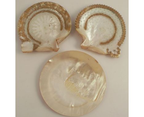 A pair of mother of pearl shells, etched with geometric patterns and traces of gilt decoration, together with a turned mother