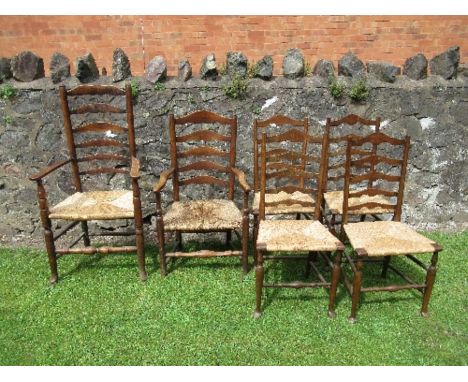 A harlequin set of six ladder back country chairs, with carved seat, four singles and two similar armchairs