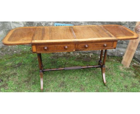 A 19th century rosewood and satinwood sofa table, fitted with a pair of end fall flaps, two real frieze drawers and two dummy