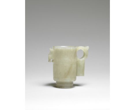 A pale green and russet jade cupYuan/Ming DynastySolidly carved in cylindrical form, raised on a tall ribbed foot, one side w