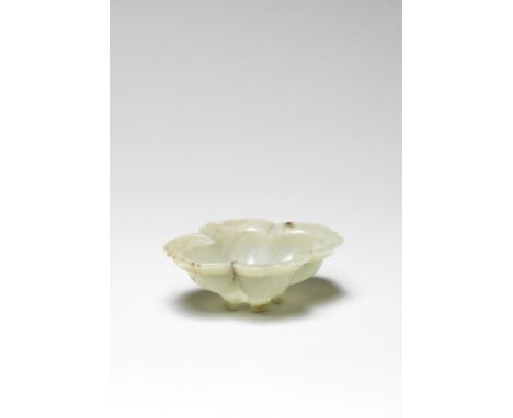 A rare pale green jade quatrelobed 'lotus' shaped brush washer17th centuryThe vessel delicately carved with four fleshy lobed