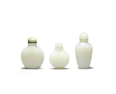 Three white and pale green jade snuff bottles18th/19th centuryAll well hollowed, the first of ovoid form, carved in relief on