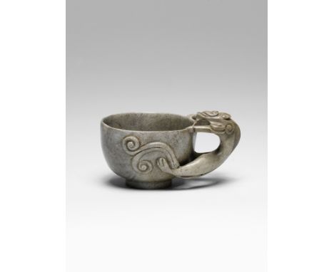 A 'chicken-bone' jade 'chilong' cupMing DynastyThe deep rounded cup smoothly carved, a large chilong with bifurcated tail bit