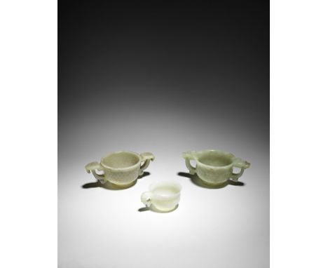 three archaistic jade cups16th/17th centuryComprising two archaistic two-handled cups, the first carved with a band of raised