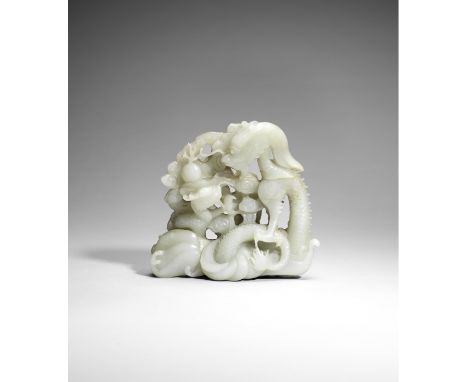 A pale green jade 'dragon and young' groupQianlongDeftly carved and pierced as a large scaly dragon emerging from finely inci