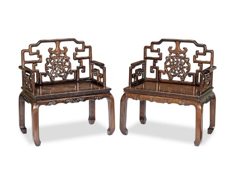 A pair of hongmu and huali armchairs19th centuryEach with stepped toprails above upright backs with central splats carved and