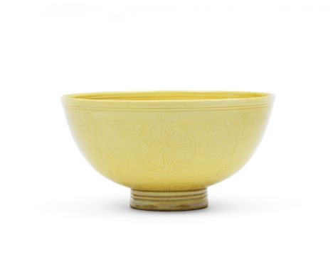 A rare yellow-glazed incised bowlKangxi six-character mark and of the periodIncised around the exterior with four floral meda