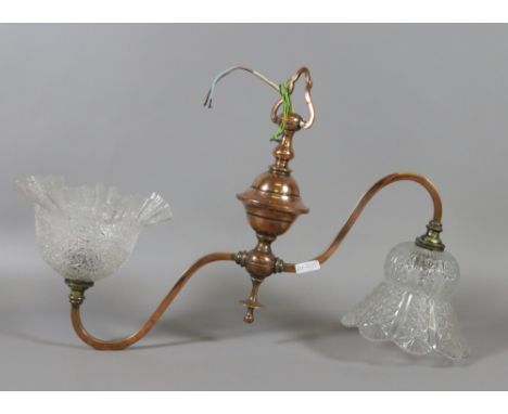 An Edwardian copper twin branch ceiling light with crimped glass shades.