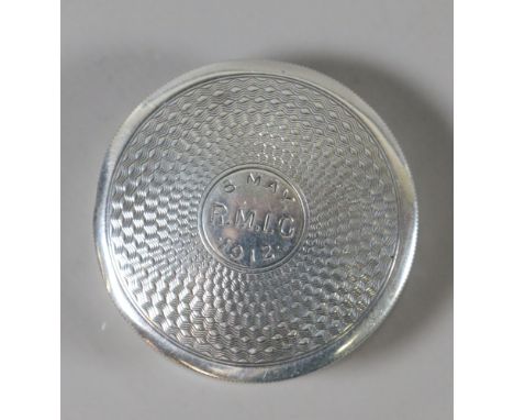 A small circular silver pill box with engine turned decoration, assayed Birmingham 1911, 22.49 grams.