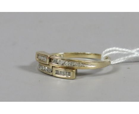 A ladies 9ct gold and diamond set crossover ring, UK size W. 3.44 grams.