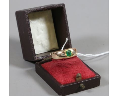 A 14ct gold ring set with a square cut emerald flanked by a pair of diamonds stamped 585 ring size P, 7.6 grams.