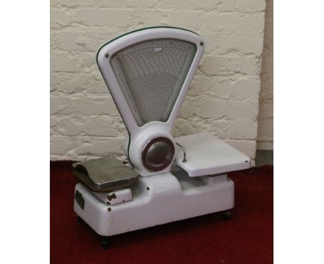 A pair of Avery white enamel metal shop weighing scales.