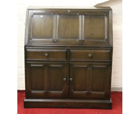 An Ercol fallfront bureau with fitted interior.