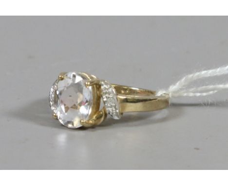 A ladies 9ct gold and white paste ring with diamond set shoulders UK size N. 3.59 grams.